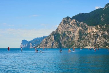 scenic sea and mountains, windsurfing camp, sailing people