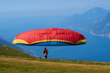 parachutist man getting ready to fly, action sport in mountains 