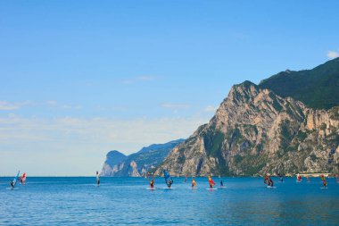 scenic sea and mountains, windsurfing camp, sailing people