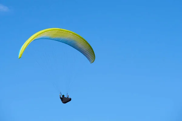 blue sky and parachutist skydiving in sky 