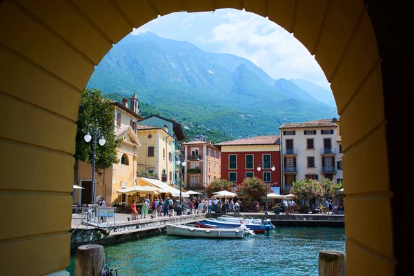 port town, small town with people at sea water, building arch 
