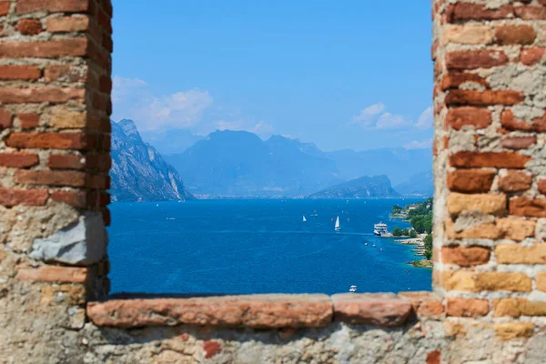 beautiful view, blue lake water and sailing boats, brick building window  