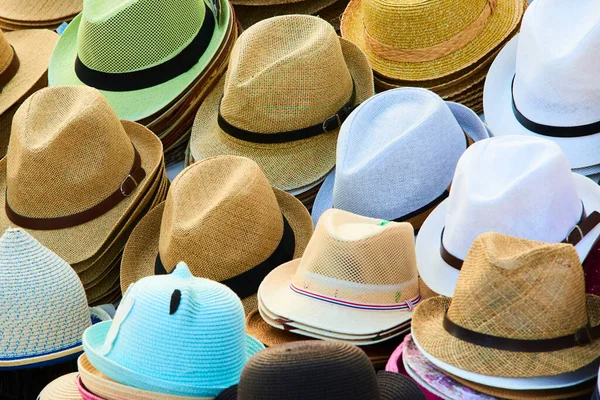 straw and summer season hats on the shelves in market