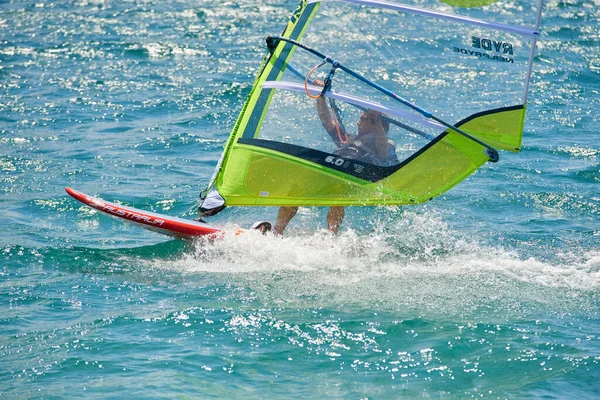 sailing and surfing man in sea water, windsurfing sport activity at summer 