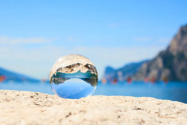 transparent glass ball, sphere on stone