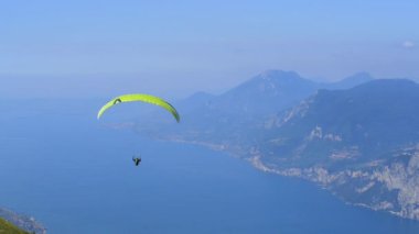 parachutist skydiving in sky, action sport in mountains 