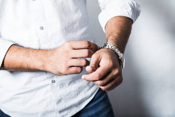 Man in white shirt and metallic wrist watch