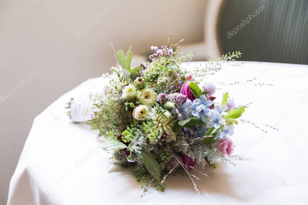 Wedding bouquet of wild flowers on table