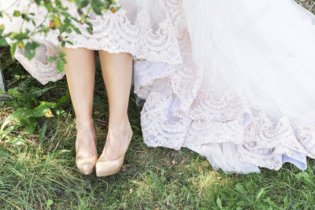 Bride in beautiful shoes outdoors