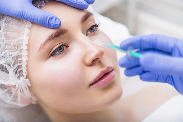 Woman receiving beauty plastic injection on her nose — Stock Photo, Image