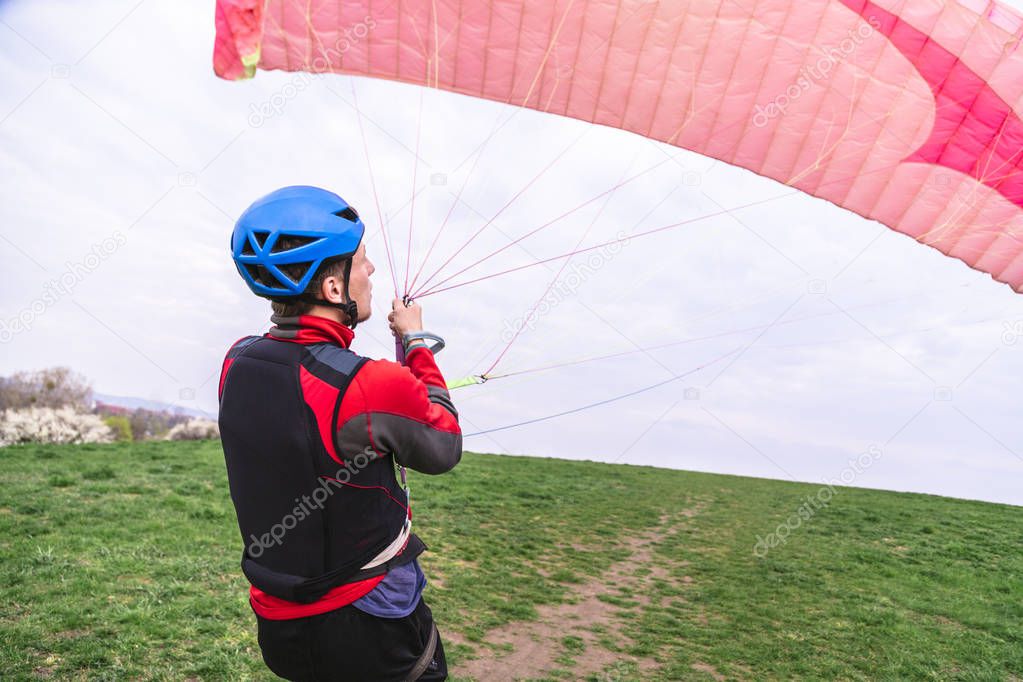 Skydiver pulls parachute behined him after landing