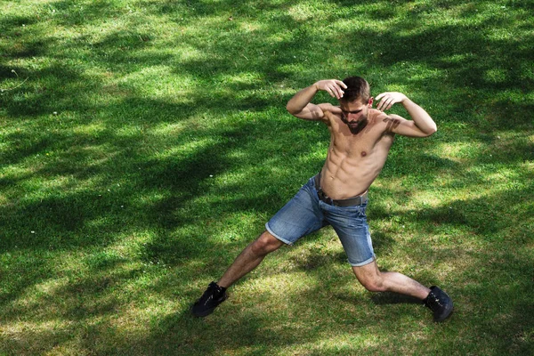 Man dancing in park raised his hands to his head — Stock Photo, Image