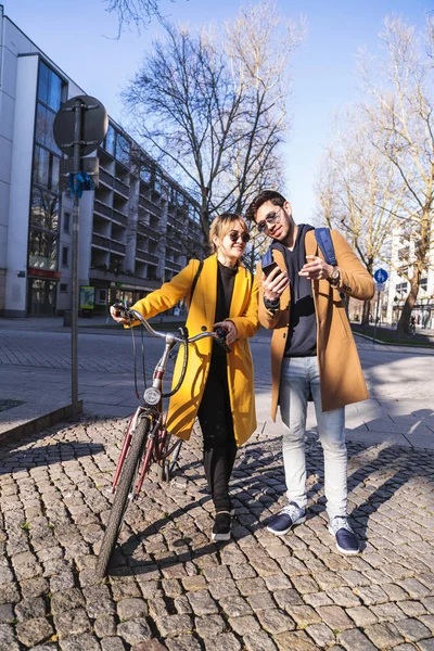 Young hispanic man looks some information in phone