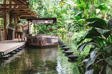 Turistler ormanda iskeleye demirlemiş eski tekne kurulu