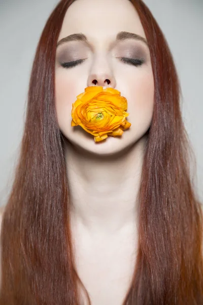 Beautiful young girl with yellow rose in her mouth — Stock Photo, Image