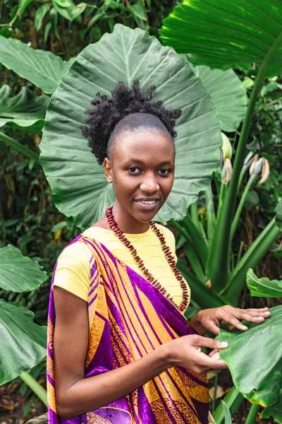 African american woman in jungle in colorful dress