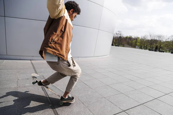 African american man makes jump on his skateboard