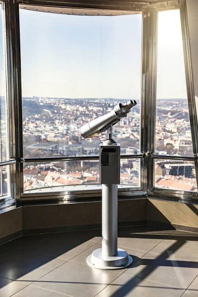 Telescope in observatory in Prague against window