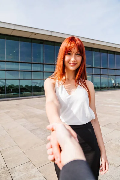 Young redhead business woman in formal outside