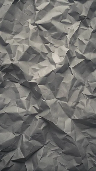 Gri kırışıklıklar ve gölgeli buruşuk kağıt dokusu, grunge markalaşması, kenar posterler ve alternatif tasarım projeleri için mükemmel..