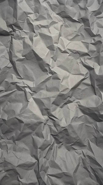 Gri kırışıklıklar ve gölgeli buruşuk kağıt dokusu, grunge markalaşması, kenar posterler ve alternatif tasarım projeleri için mükemmel..