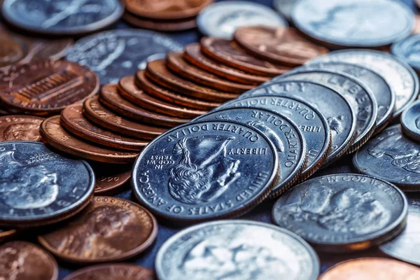 Pile of Golden coin, silver coin, copper coin, quarters, nickels