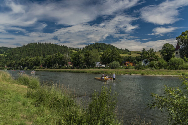 Wooden boats on Dunajec river in Pieniny national park near Poland and Slovakia border in summer day in Cerveny Klastor town