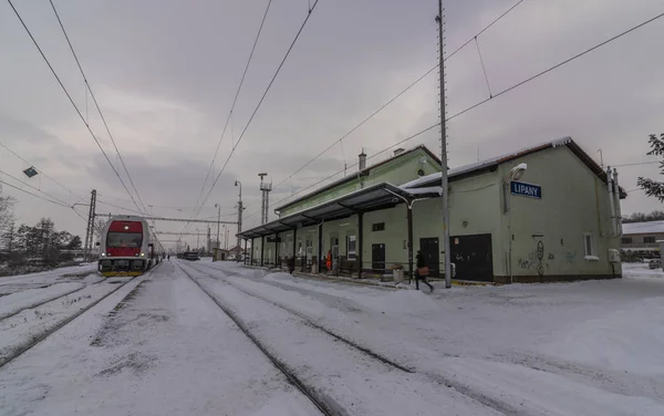 Lipany station in winter snow morning with trains and platforms