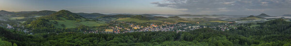 View from Jehla hill over Ceska Kamenice town in spring misty morning