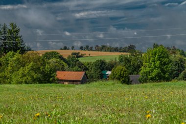 Green meadow and fields with old rural buildings in Roprachtice CZ 08 31 2025