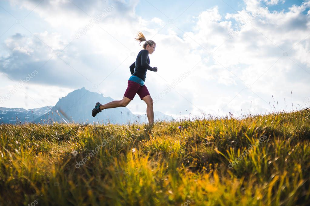 Sportive Girl running in Mountains