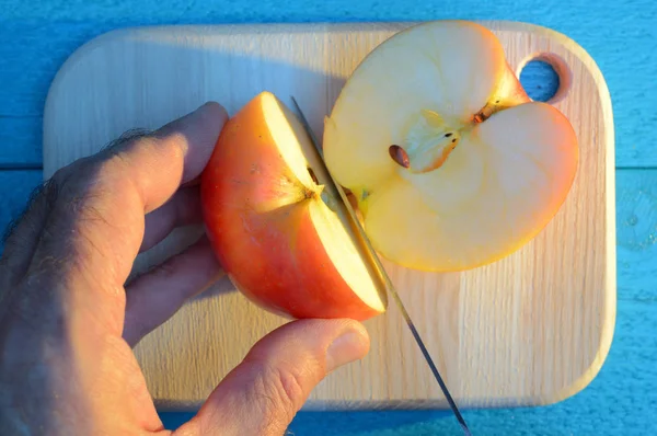 Cutting Apple His Hand Knife Cutting Wooden Cutting Board Turquoise — Stock Photo, Image