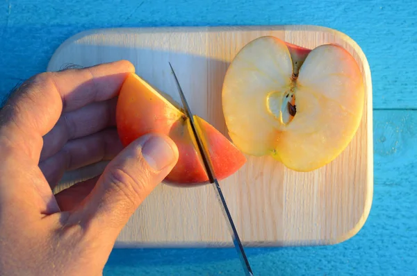 Cutting Apple His Hand Knife Cutting Wooden Cutting Board Turquoise — Stock Photo, Image