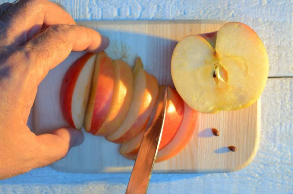 Chopping Apple His Hand Knife Cutting Wooden Cutting Board White — Stock Photo, Image