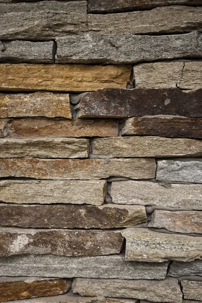 Stone background. Decorative stone wall, sandstone texture, masonry background for design. Vertical image.