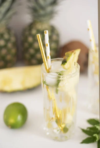 Cold pineapple cocktail with crushed ice, lime, coconut and mint, tropical refreshing lemonade drink — Stock Photo, Image
