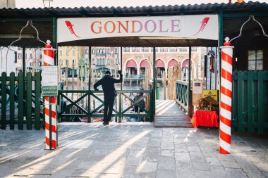 Venice, Italy - January 3, 2019: People docking of santa sofia gondolas on Grand Canal clipart