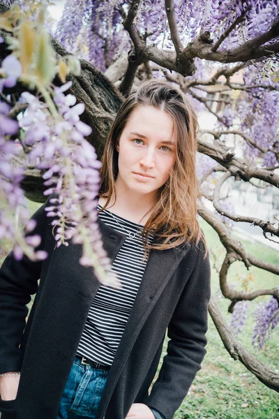 咲く藤の近くで屋外でかわいい十代の少女の肖像画 — ストック写真