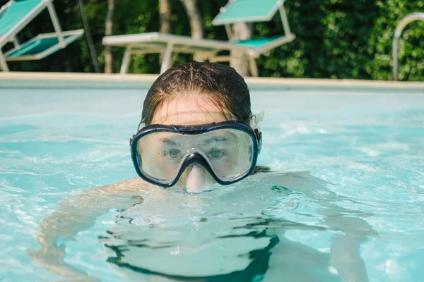 Girl with diving mask in the pool