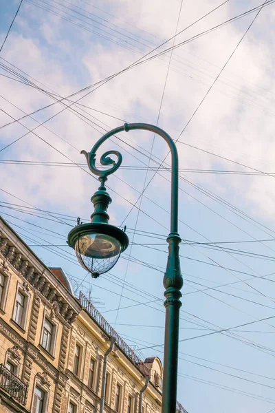 Lâmpada de rua, fios, sinal de rua contra o céu azul — Fotografia de Stock