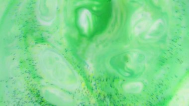 Soyut Renkli Boya Mürekkebi Patlaması Psikedelik Patlama Hareketi. yumuşak renkler, soyut kompozisyon. Yeşil mermer zemin ile akrilik dokusu 