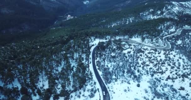 드론으로 겨울에 눈덮인 아름다운 구불구불 한길을 내려다본 — 비디오
