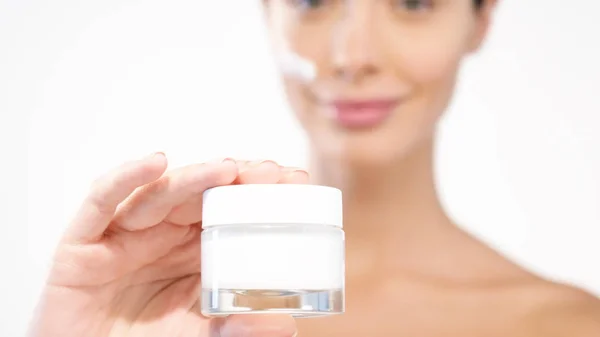 Woman Holding Cream Bottle Moisturizing Cream Face Looking Camera — Stock Photo, Image