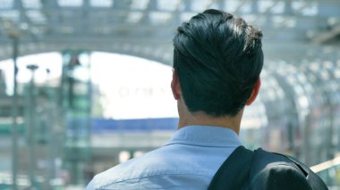 Takım elbiseli Genç yakışıklı işadamı (öğrenci) portresi arkadan görünüm istasyonunda havaalanında. Konsept: yeni iş, seyahat dünya, iletişim, kişiler, iş anlaşması