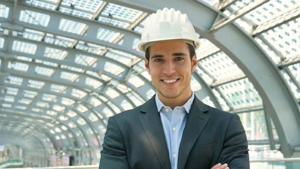 architect man in white helmet looking at camera with smile