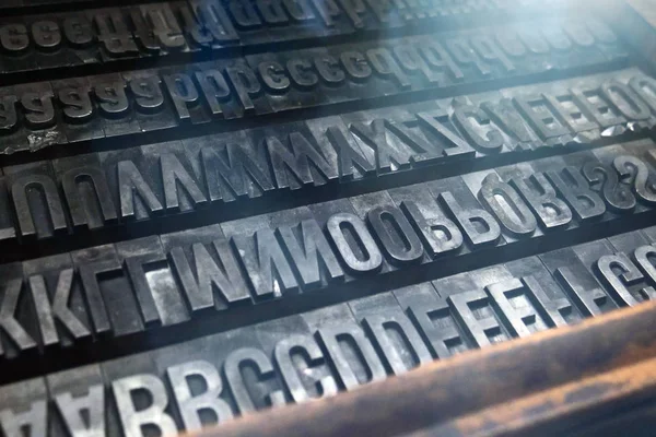 Macro shot of metallic letters used in the printing of the 90s newspapers. Concept of freedom of thought, letters, newspapers and news.
