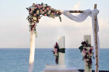 Bir düğün denizin içinde belgili tanımlık geçmiş ile dekore edilmiş bir kemer portresi.