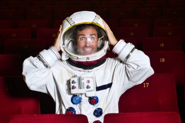 Astronot bir film pop mısır yemek ve film zevk görünüyor. Kavramı: sinema ve uzay filmleri, film diğer dünya, gerçeküstü durumlar.