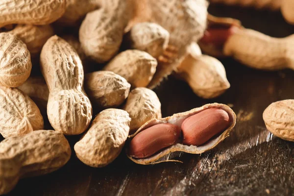 Composition of peanuts serving to make oil, peanut butter. Great for healthy and dietary nutrition. Concept of: condiments, dried fruit, food.