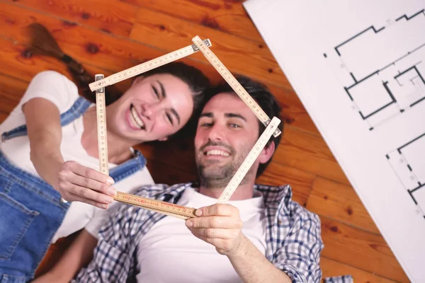 Lächelndes Kaukasisches Verliebtes Paar Auf Holzboden Liegend Mit Raumplan Und — Stockfoto